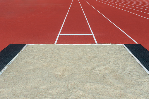 Long jump pit in a stadium. Horizontal sport theme poster, greeting cards, headers, website and app