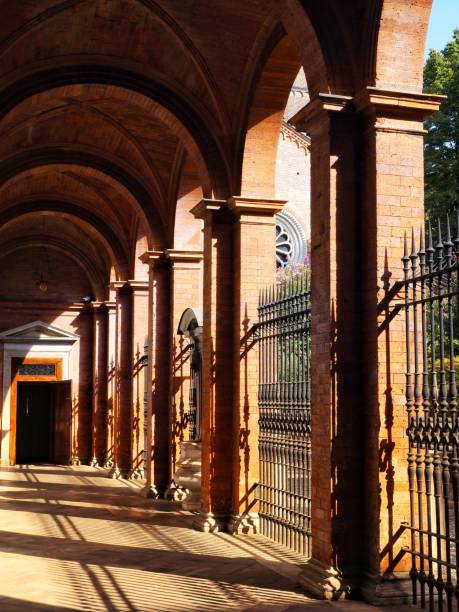 istock long walkway lined with arches and gates under a building with large columns 1503471787
