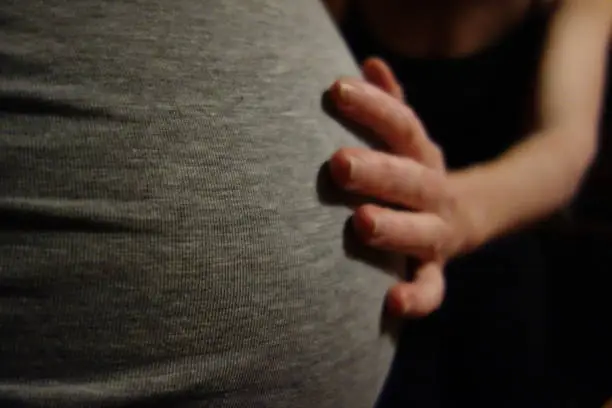 a pregnant woman with a baby bump, child before birth