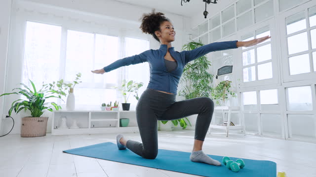 Young black pregnant woman exercising at home