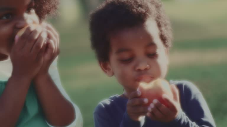 Group of African children eating apples