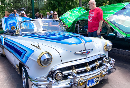 Santa Fe, NM: Tourists admires a vintage painted lowrider Chevy on the historic Santa Fe Plaza on the annual (June) Lowrider Day.