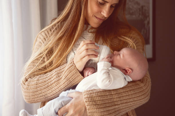 istock Mother feeding her newborn son with a bottle 1503491542