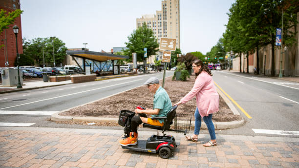 istock Social worker helps senior man on mobility scooter 1503491600