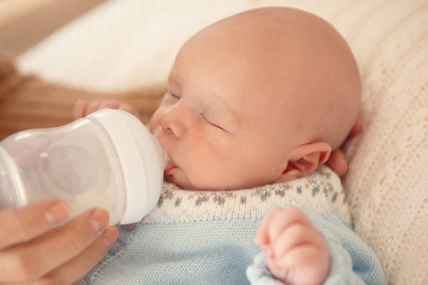 Mother feeding her newborn son with a bottle - Buenos Aires - Argentina