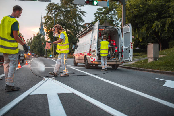 istock Road Maintenance Crew Repainting A Forward Pointing Arrow Road Sign 1503534836