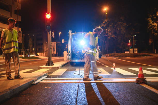 istock Road Maintenance Crew Spray Painting A Crosswalk 1503534854