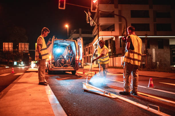 istock Road Maintenance Crew Repainting A Turn Left Road Sign 1503534868