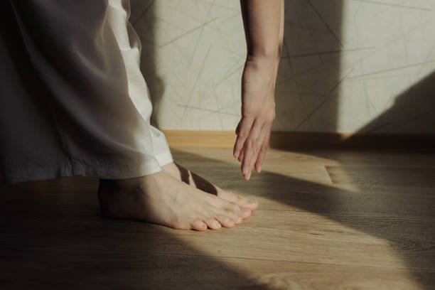 istock Barefoot woman doing yoga exercise and stretching at home 1503536141
