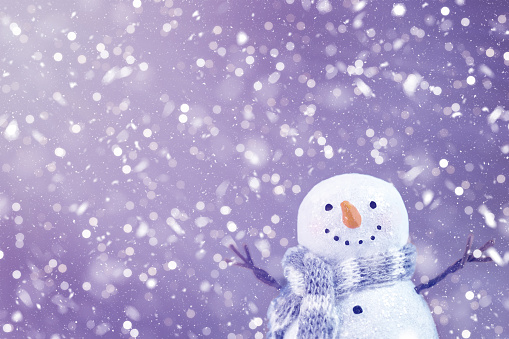 Happy snowman cheering for the falling snow. Majestic conceptual image for winter holidays. Image contains copy space. Can be used as Christmas greeting card or New Year greeting card. Can be used for winter holidays storytelling, holiday invitations etc. Not AI