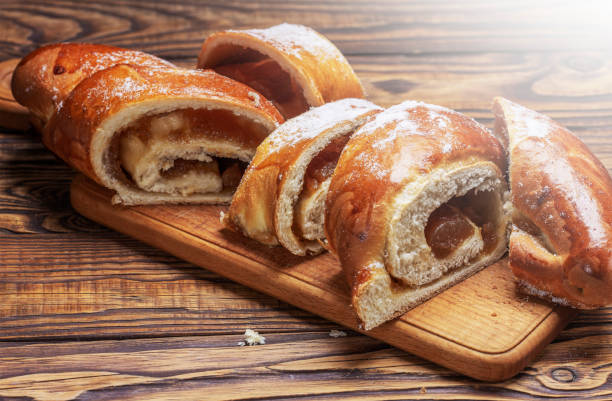istock cut sweet bun with jam on a wooden board 1503568218