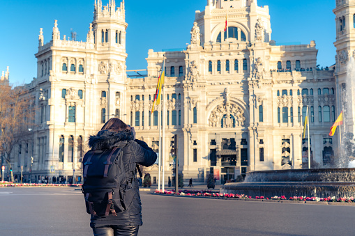 Historic building of Madrid, the metro station and people passing by