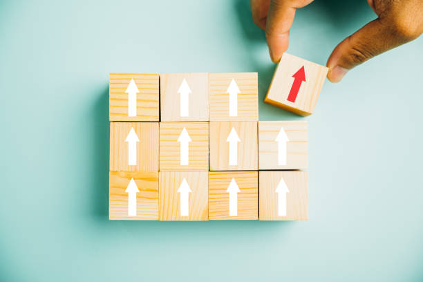 istock male hands stacking wooden blocks as steps on a white table 1503645362