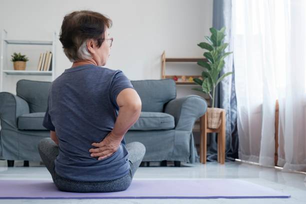 istock Elderly woman with back pain holding her lower back. 1503662033