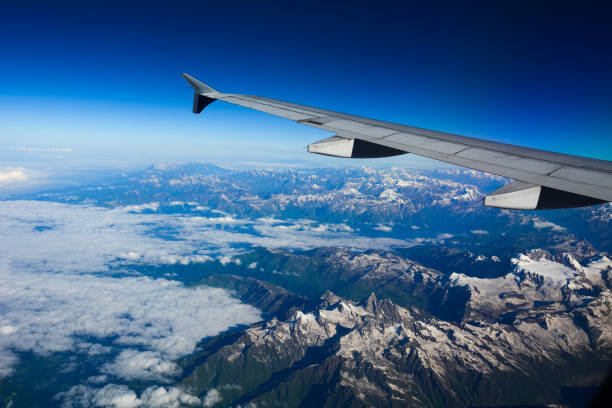 istock View from airplane to mountains and clouds 1503677043