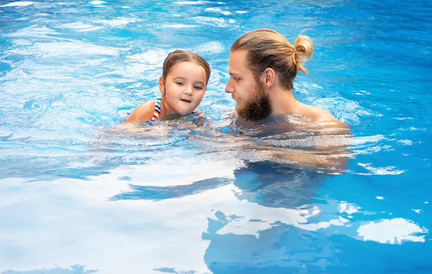 istock Man and daughter swimming 1503677083