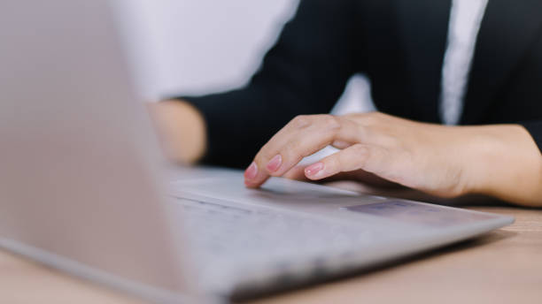 istock business woman typing working on laptop computer while sitting at home, selective focus on hand 1503700776