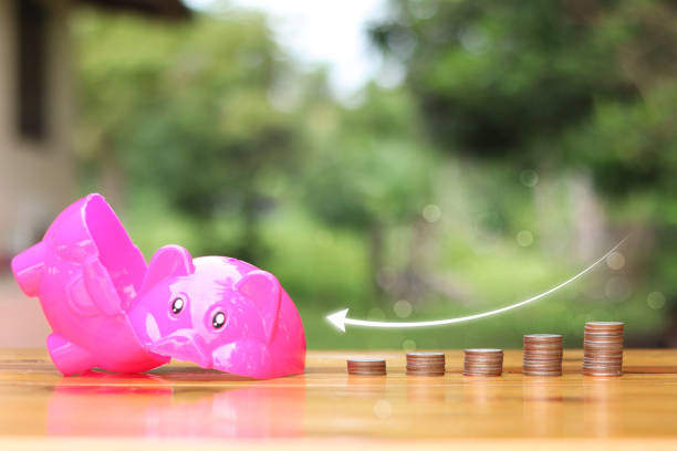 istock A Broken piggy bank with coins on the side. 1503704779