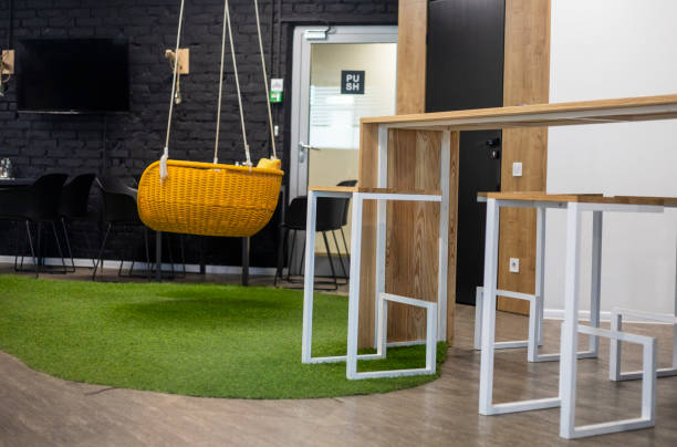 istock yellow hanging swing chair in the office for relaxing with bar stools. Modern interior 1503708317