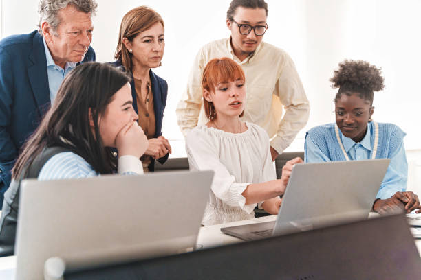 istock Redhead Woman Presenting Project to Colleagues 1503708828