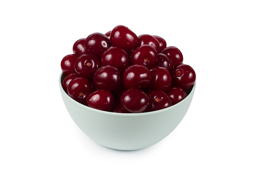 Bowl with ripe natural cherries on a white background. Natural organic cherries. Wet sweet cherries.