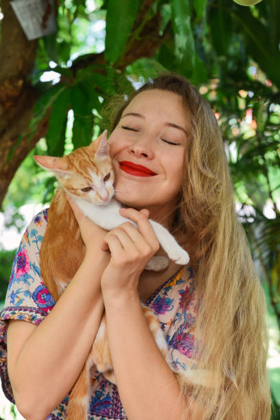 istock Young blond woman hugging her red cat 1503720145