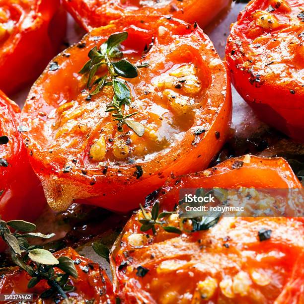 Close Up Of Roasted Red Cherry Tomatoes Seasoned Stock Photo - Download Image Now - Baking Sheet, Cherry Tomato, Cooking