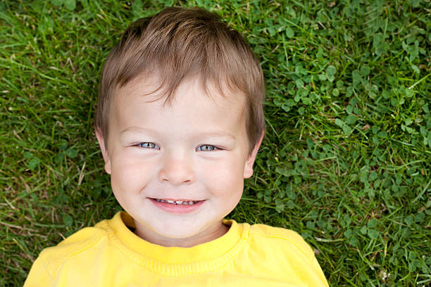 istock toddler in the grass 150375033