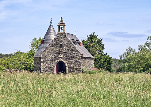 A chapel in a meadow in Rochefort-en-Terre, Brittany France.