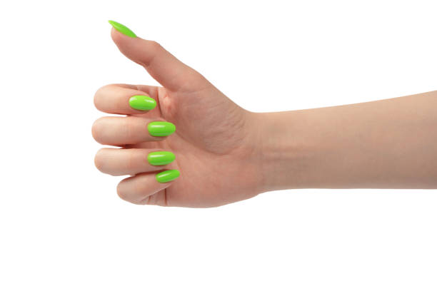 istock Hand of a woman with green naols hold some tiny or thin object. 1503757302