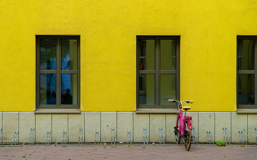 Rear view of parked bicycle against yellow building, Berlin Kreuzberg