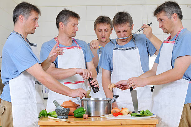 Too many cooks Composite of five cloned men trying to cook together but too many cooks have spoiled the broth cloning photos stock pictures, royalty-free photos & images