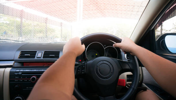 istock Man driving with both hands on steering wheel selective focus. safety driving car 1503812489