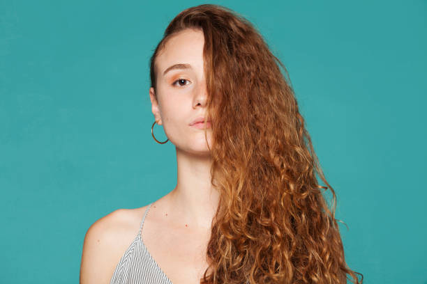 istock Charming woman with long hair standing in studio 1503821476