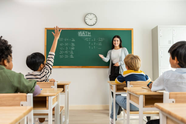 istock Group of student learn with teacher in classroom at elementary school. Attractive beautiful female instructor master explain and educate young children with happiness and fun activity at kindergarten. 1503823334