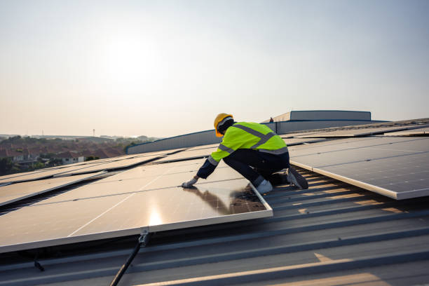 istock Professional engineer work to maintenance of photovoltaic panel system. Attractive technician worker working on roof inspect and check solar cell panels equipment box at solar cell field during sunset 1503824480