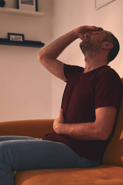 istock Man with stomach and head pain at home. 1503854705