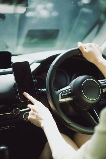 istock Asian woman using smartphone in a car 1503857674