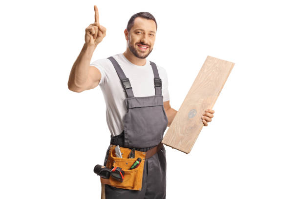 istock Carpenter holding a wooden floor beam and pointing up 1503859778