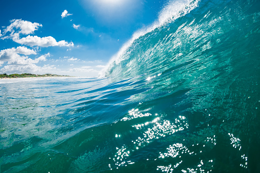 Extreme close up detail of powerful teal blue wave breaking wildly on a reef bombora off the coast of southern Australia.