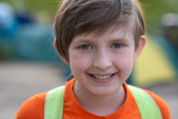 a schoolboy with a backpack came to rest in a tent camp