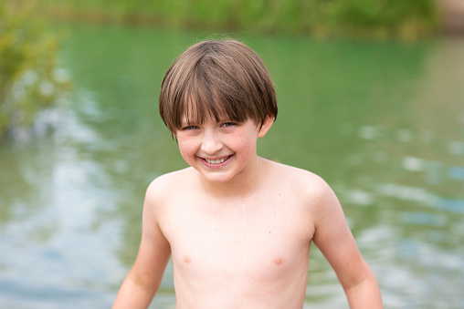portrait of a little boy before swimming in the lake