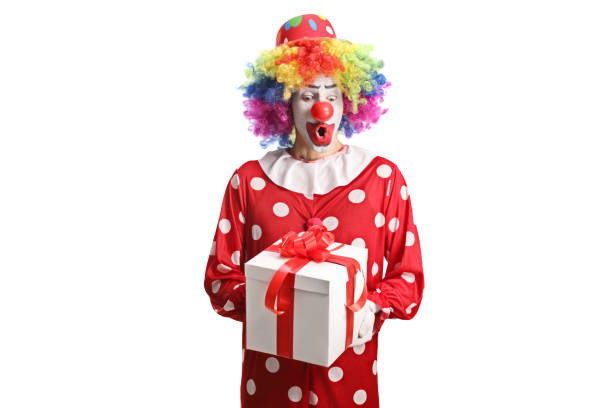 istock Clown in a red costume holding a present box 1503881229