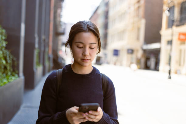 istock Asian Female Student Navigating Soho and West Village with Mobile Phone 1503899733