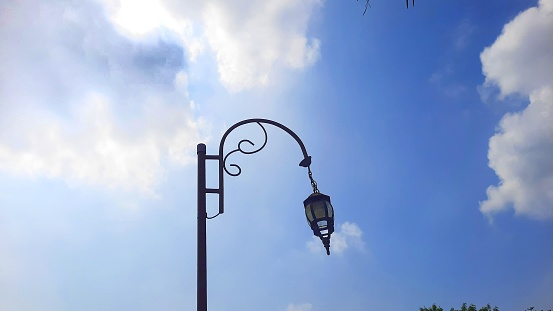 Garden lamp design with blue sky background. Blank space to write quotes or words