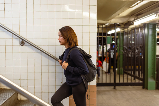Asian student navigating NYC subway