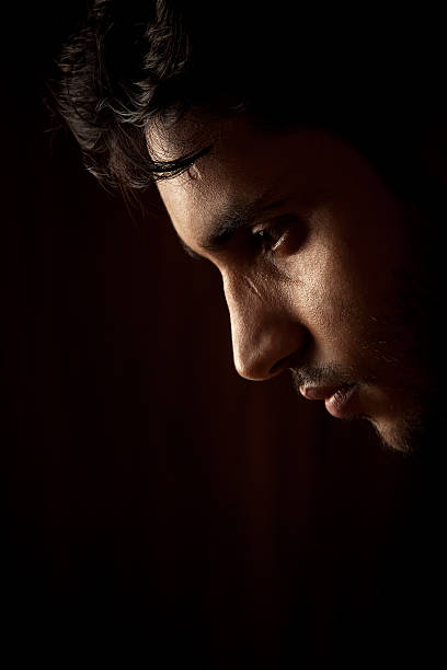istock Young Indian angry man sweating over dark 150390408