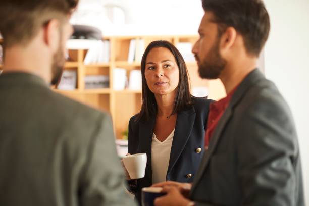 istock Coffee Break Discussion: Business Professionals Connect in Office Setting 1503914683