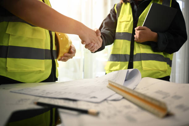 istock Architects and investor shaking hands after completing an agreement or successful construction project. 1503916340