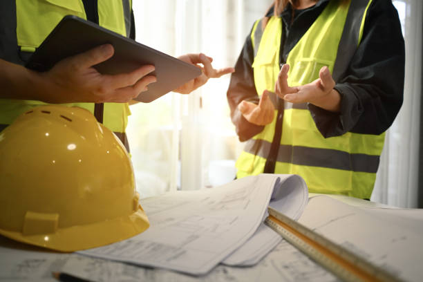 istock Team of architects discussing, working together on construction plans at modern office. 1503916368